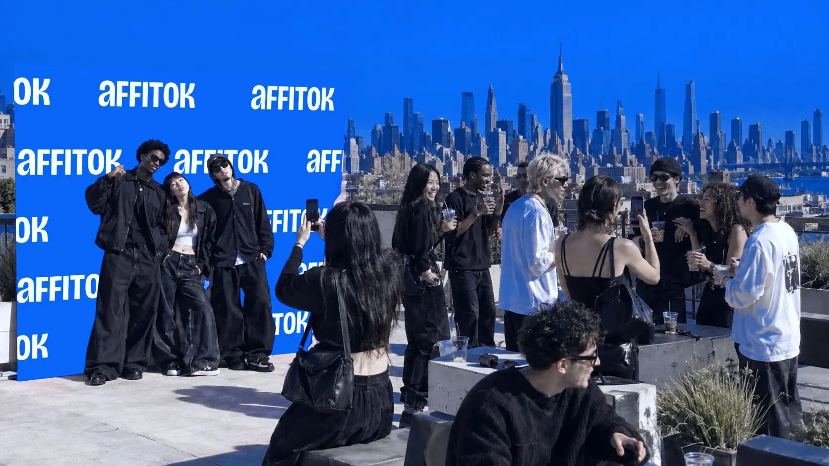 Creators posing at a step-and-repeat wall at a rooftop party in New York